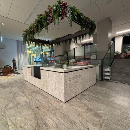 Caesarstone Clouburst Concrete benchtop and Limestone Face panels Hospitality counter commercial front counter