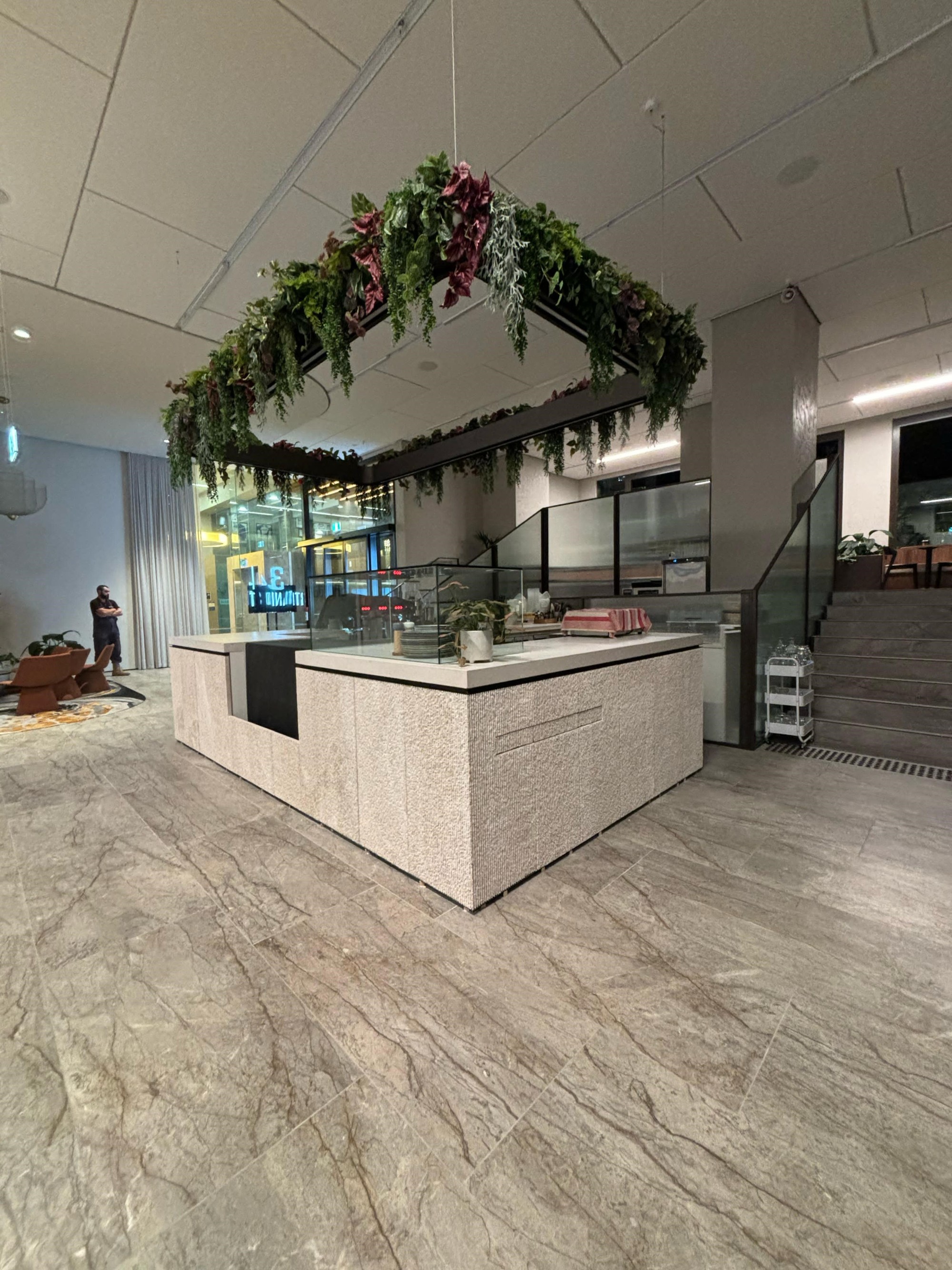 Caesarstone Clouburst Concrete benchtop and Limestone Face panels Hospitality counter commercial front counter