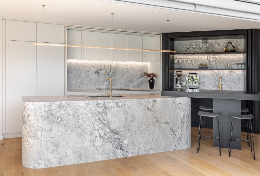 Superhwhite natural stone kitchen island with multifaceted curved waterfall end splashback coffee and bar servery No1
